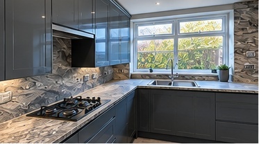 Fitted kitchen detail with graphite cabinetry, patterned stone worktop and upstand and a gas hob by C H Joinery Solutions